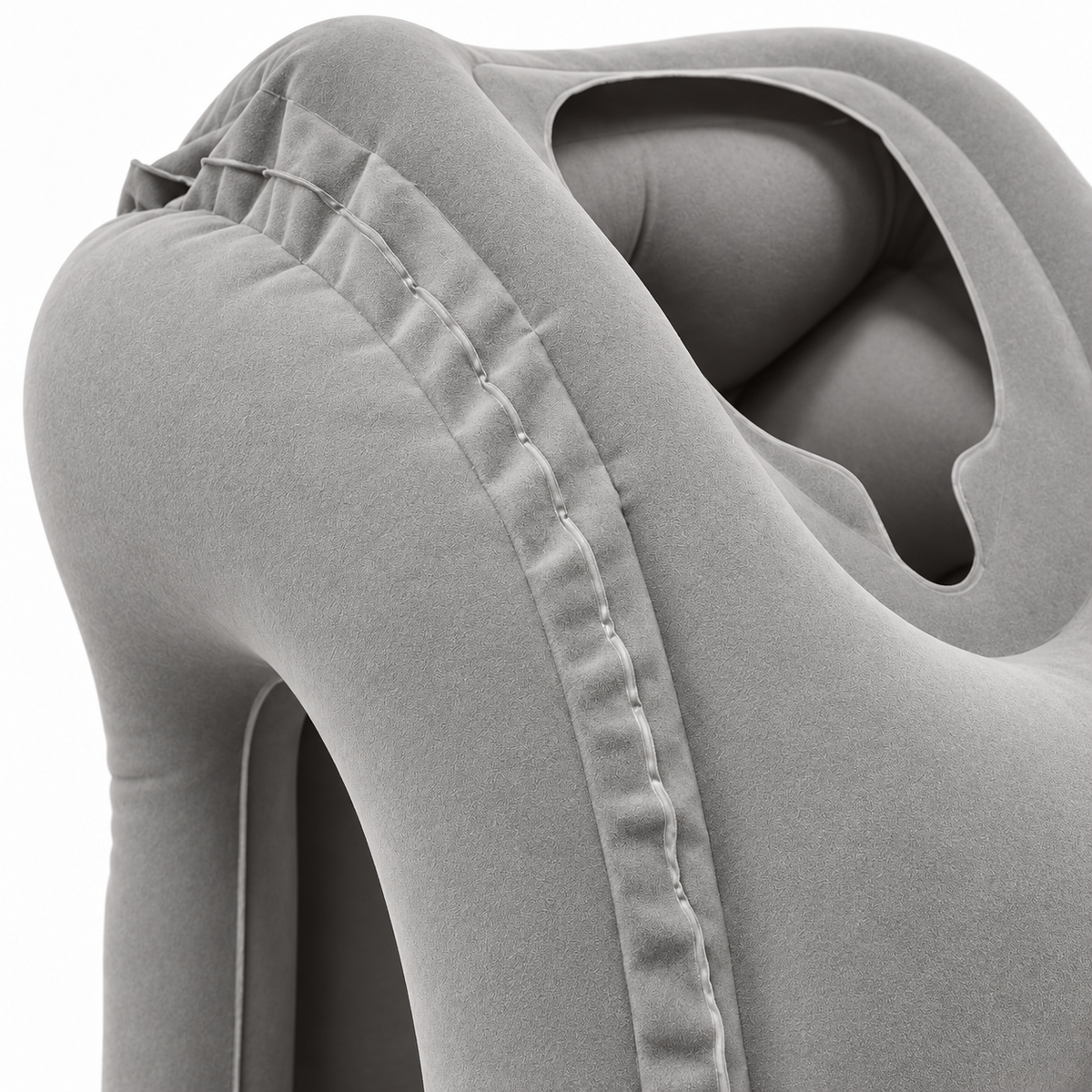 Close-up of the gray travel pillow's surface, edge seam and face opening