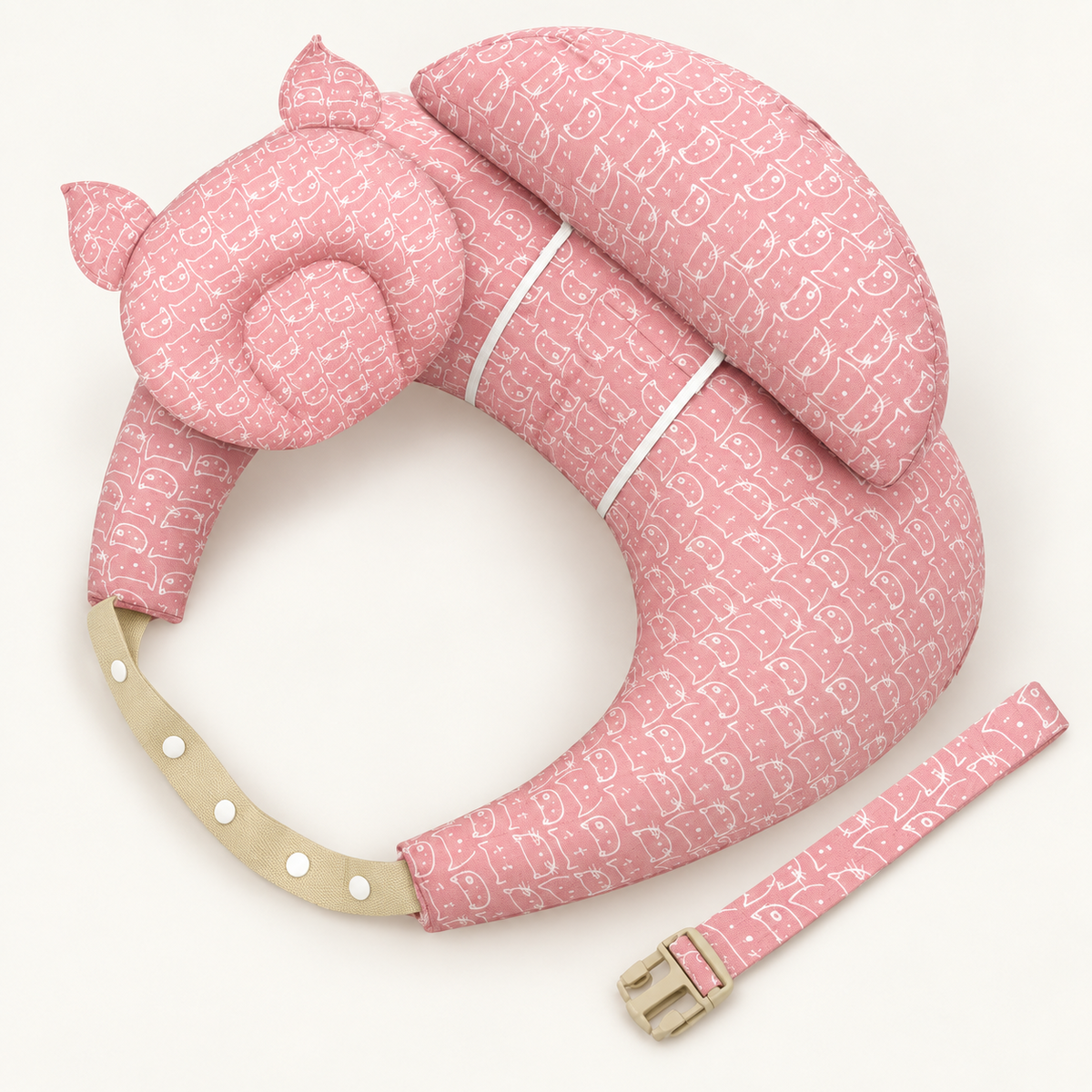 Pink cat-print nursing support pillow with matching cushions and adjustable straps on a warm white background